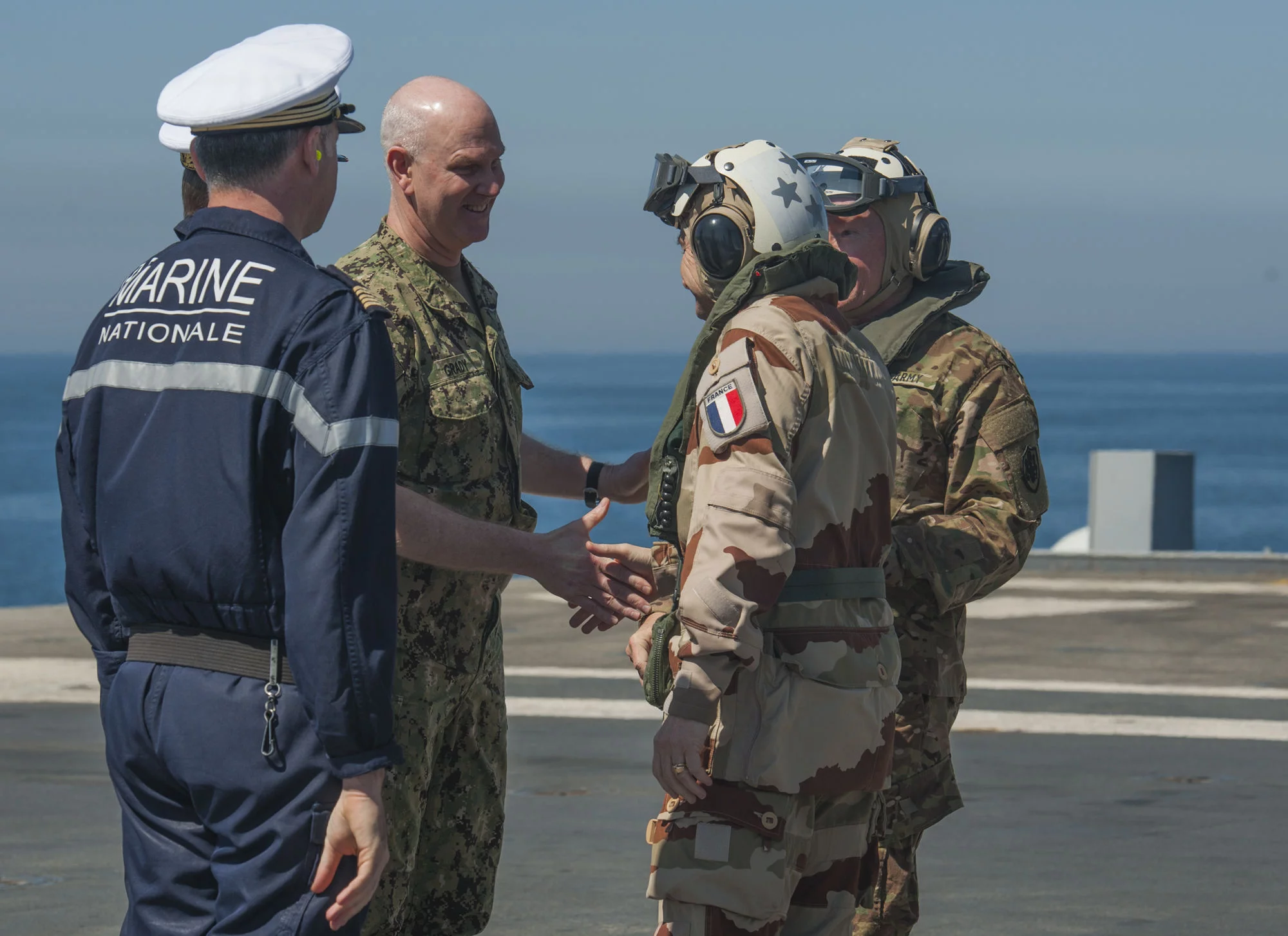 Le contre-amrail Christopher Grady, au centre, commandant du Carrier Strike Group (CSG) 1, salue le général Pierre de Villiers, chef d'état-major des armées, sur le pont du Charles de Gaulle
